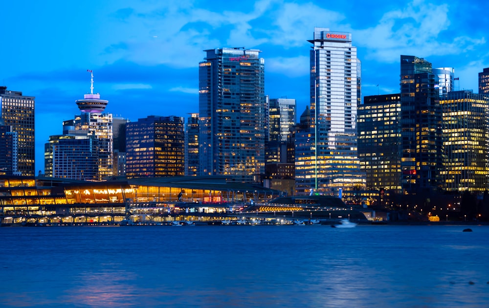 a city skyline at night with the lights on