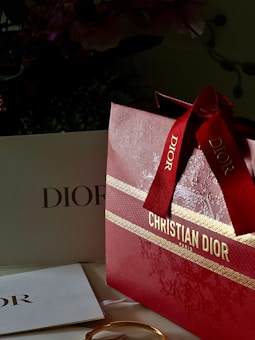 a red bag with a red ribbon on top of it