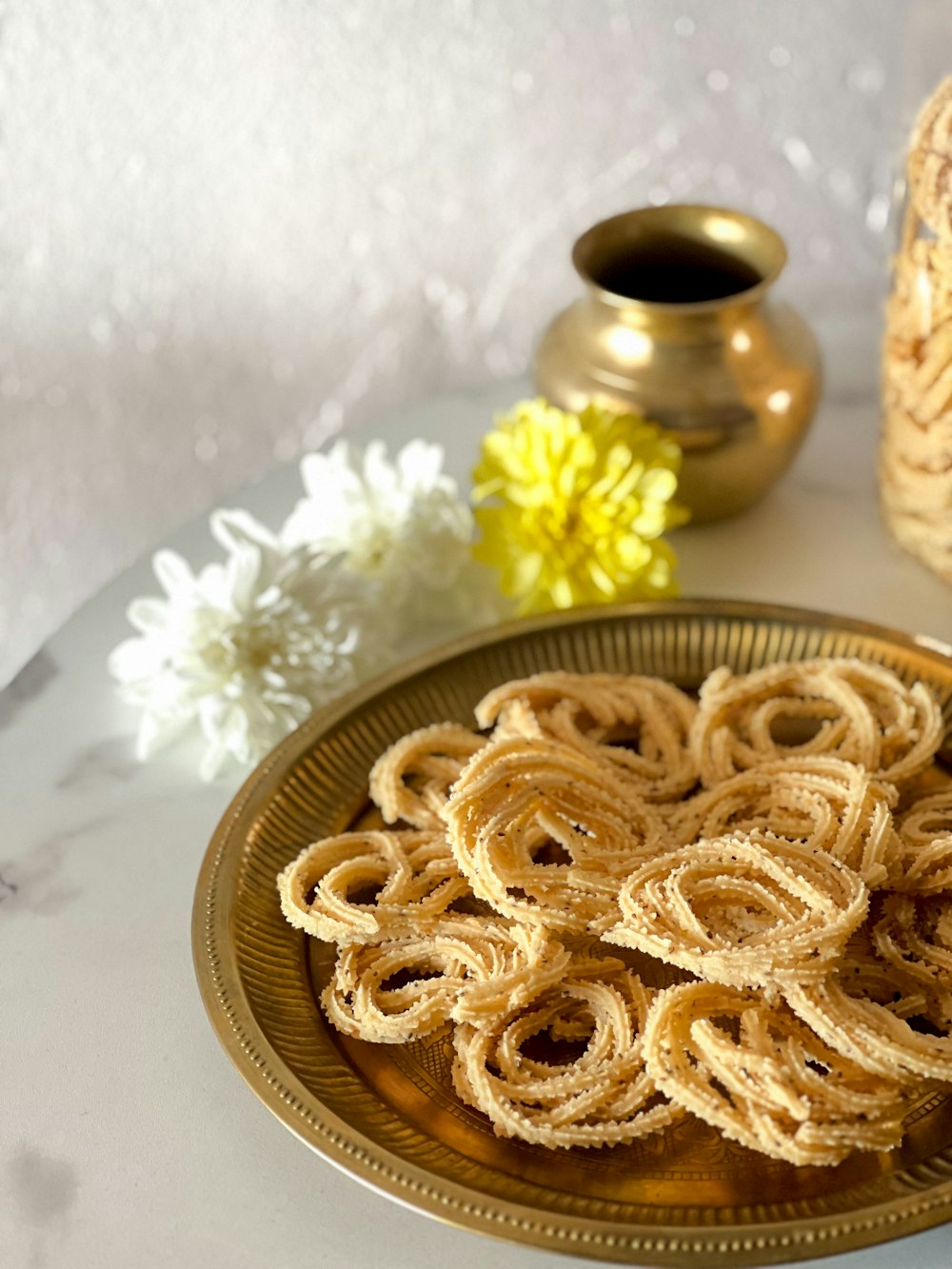 a plate of food sitting on a table next to a vase