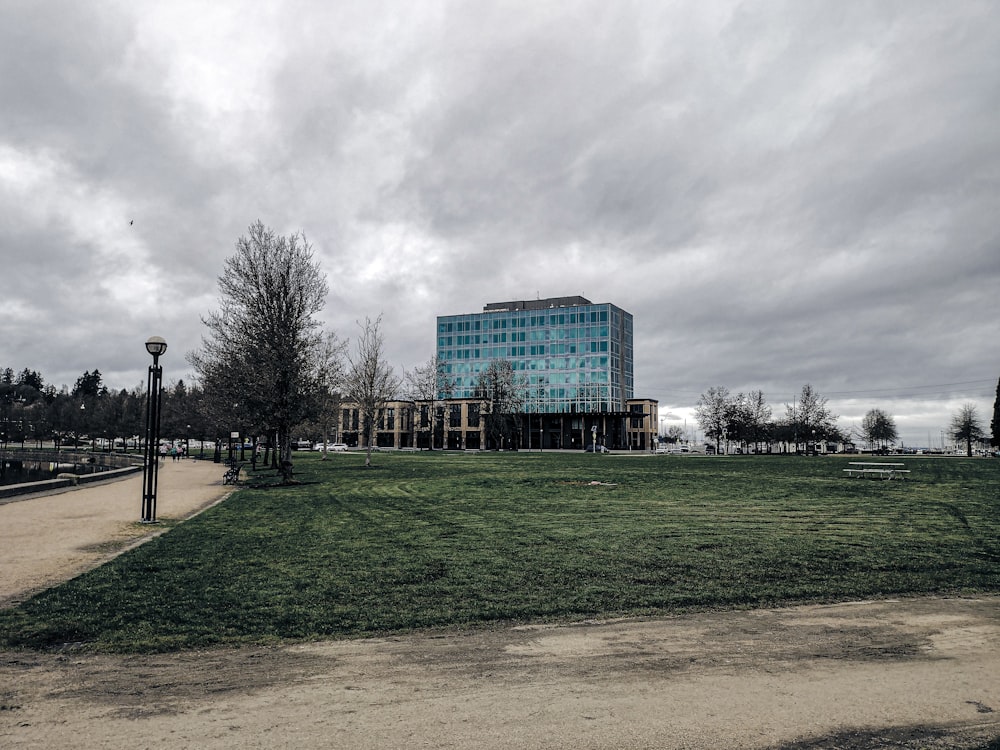 a large building sitting on top of a lush green field