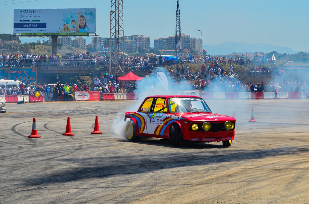 a red car with smoke coming out of it