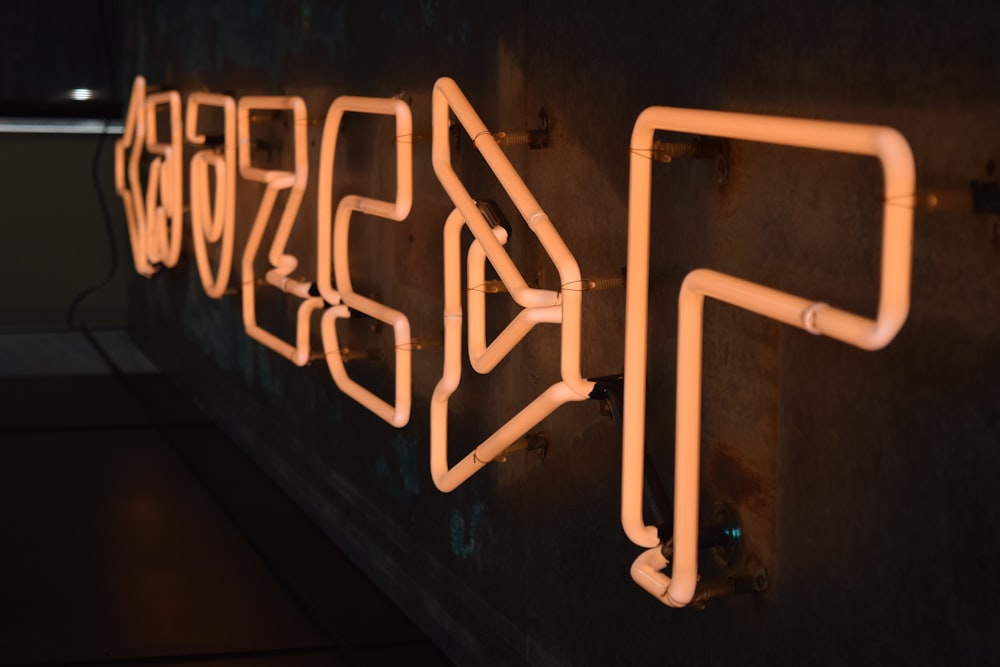 a neon sign on a wall in a dark room