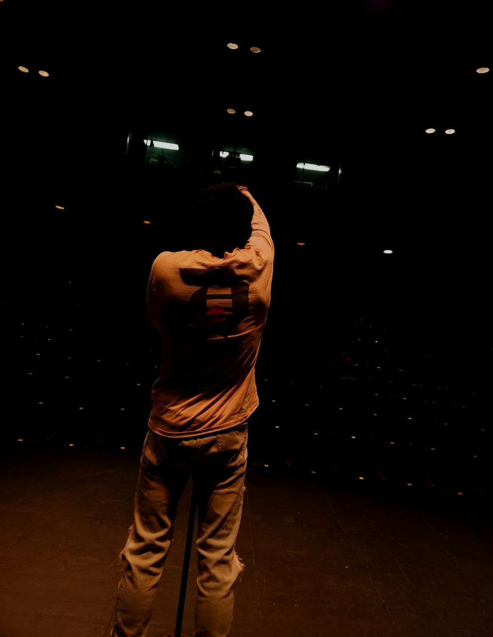 a man standing on a stage with his back to the camera