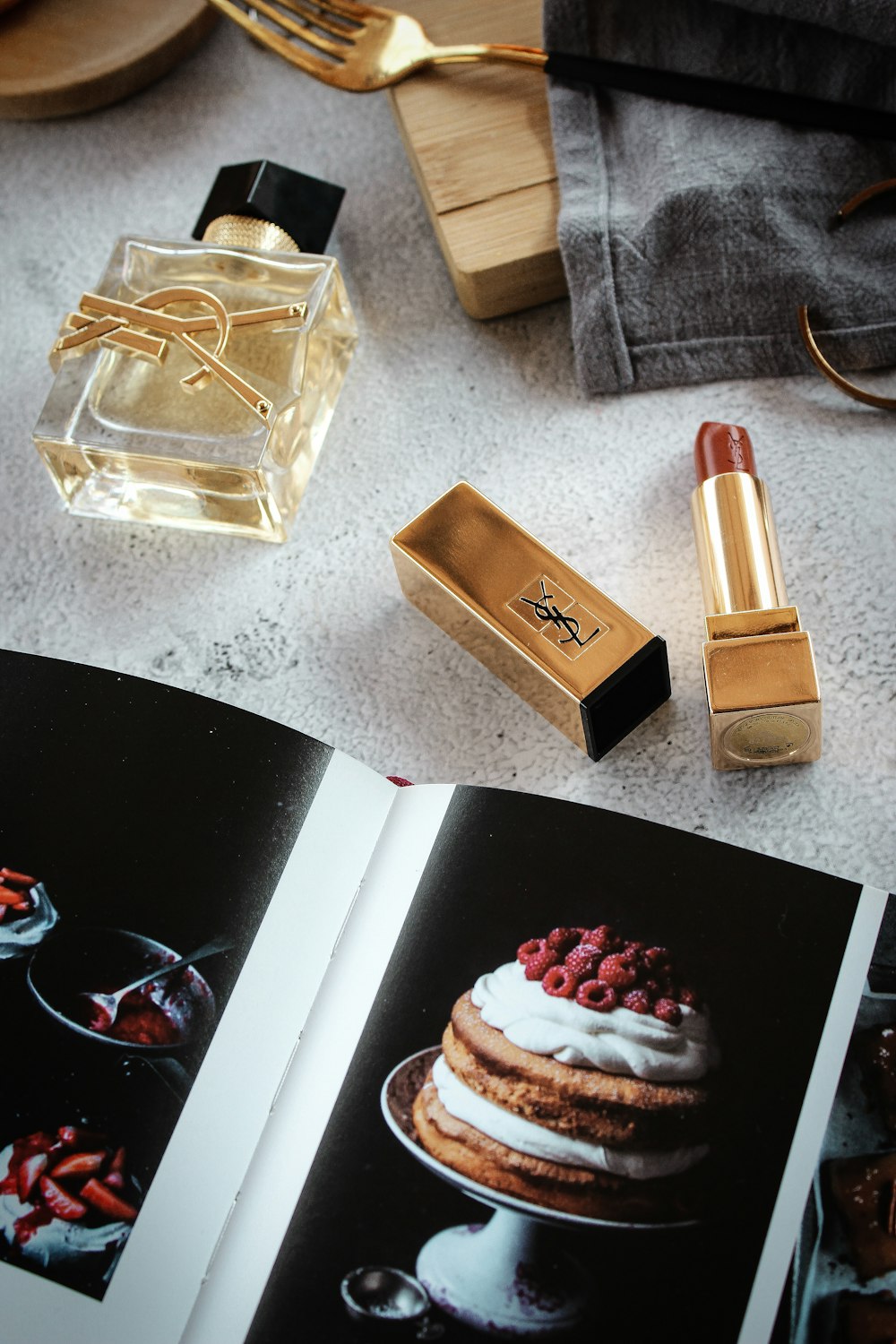 a book opened to a page with a picture of a cake and lipstick