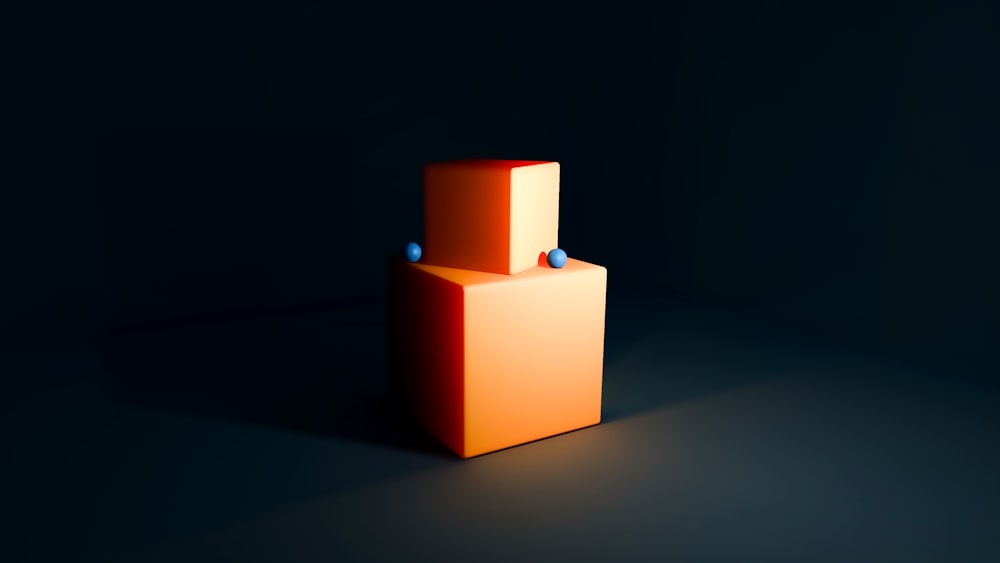 an orange cube sitting in the middle of a dark room