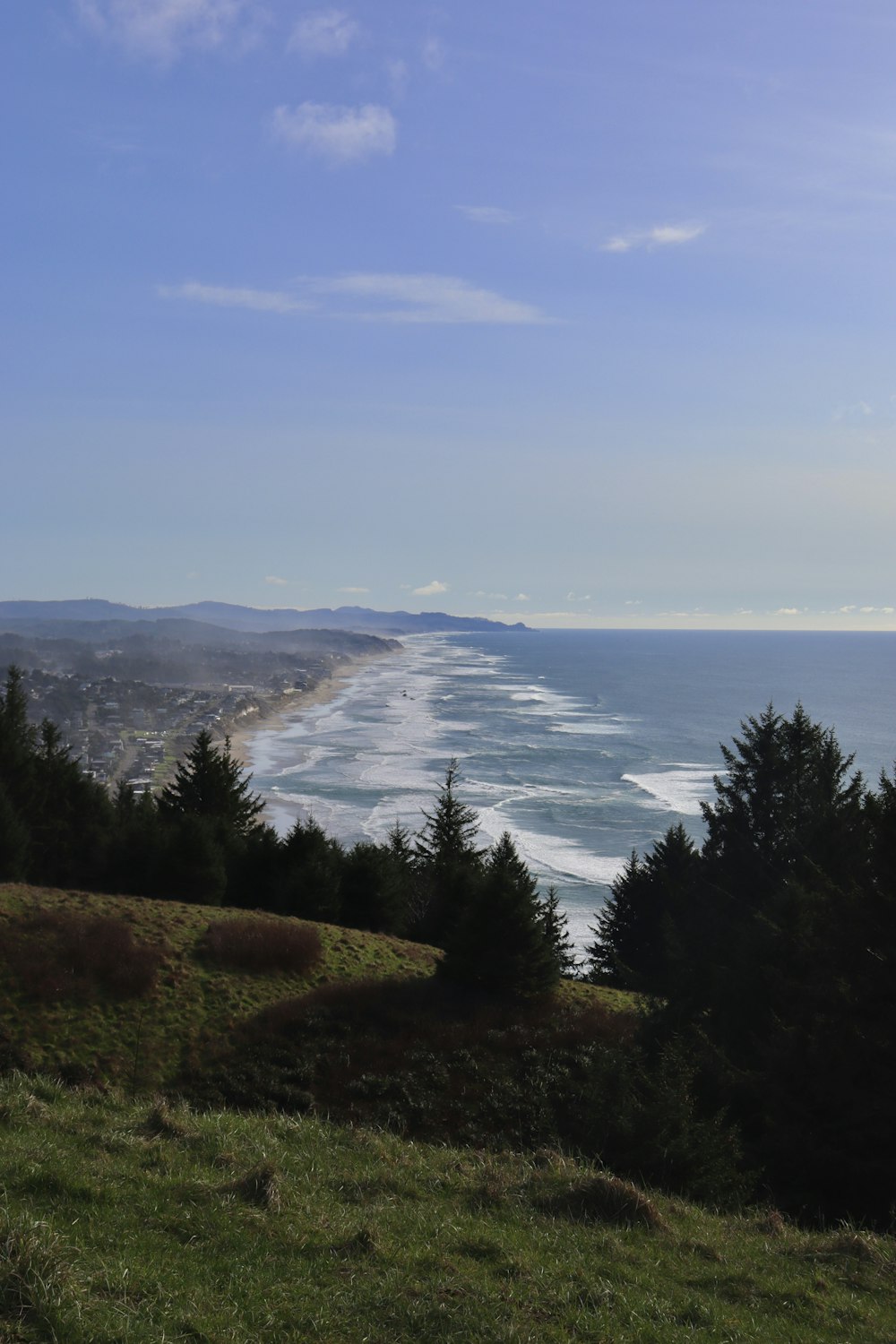 a view of the ocean from the top of a hill