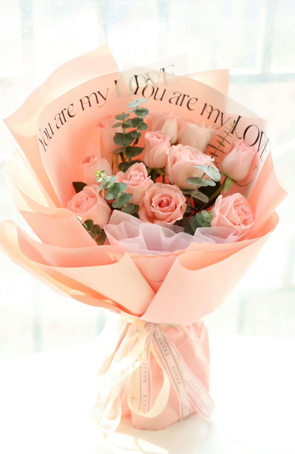 a bouquet of pink roses in a vase