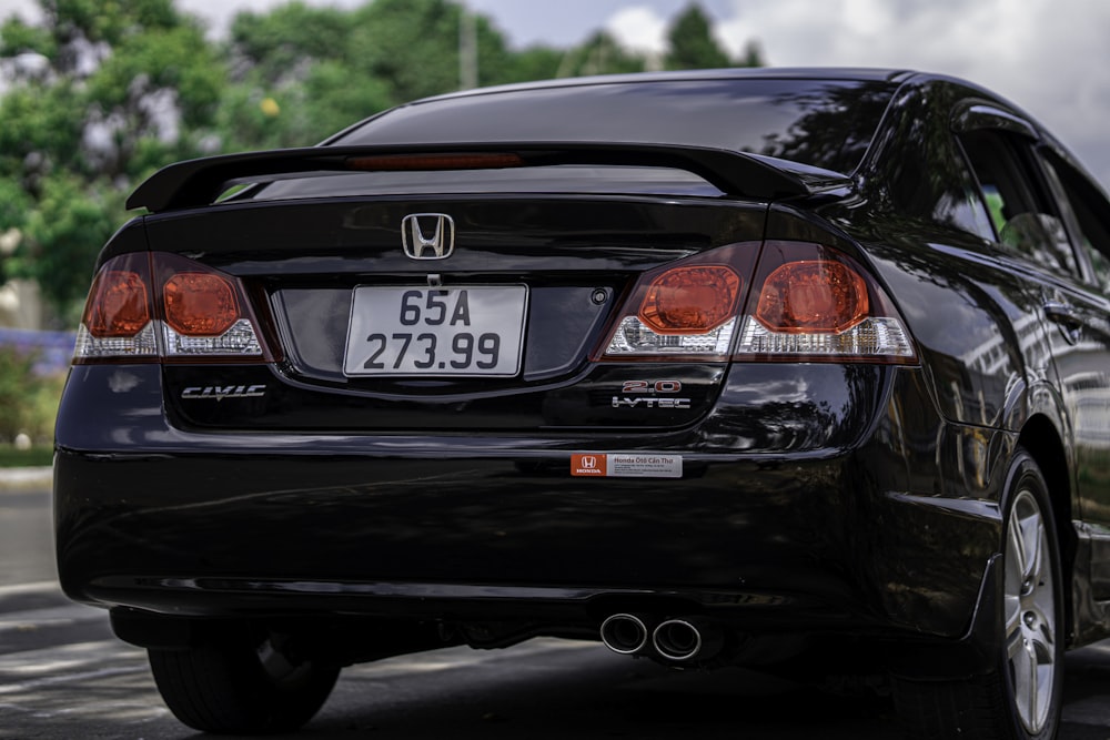 a black car parked on the side of the road