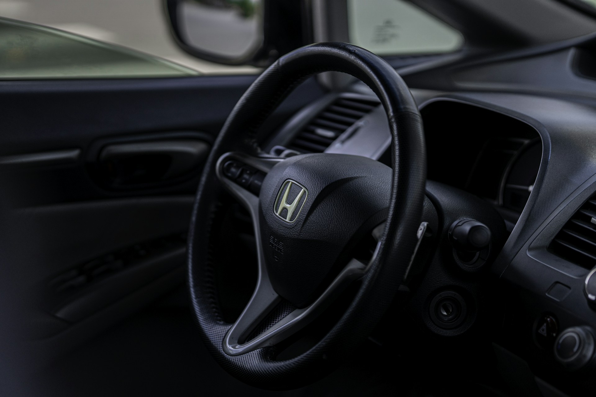 the interior of a car with a steering wheel