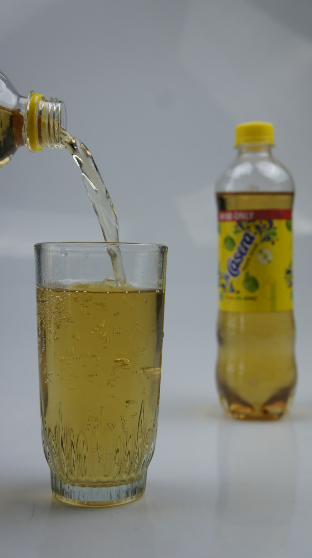 a bottle of lemonade being poured into a glass