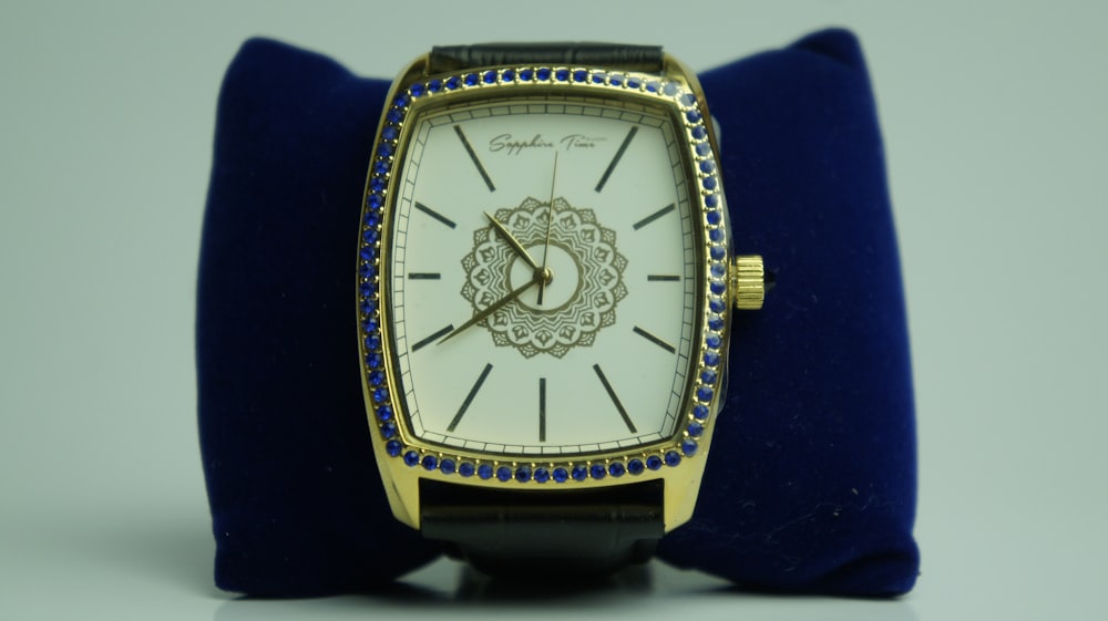 a watch sitting on top of a blue velvet case