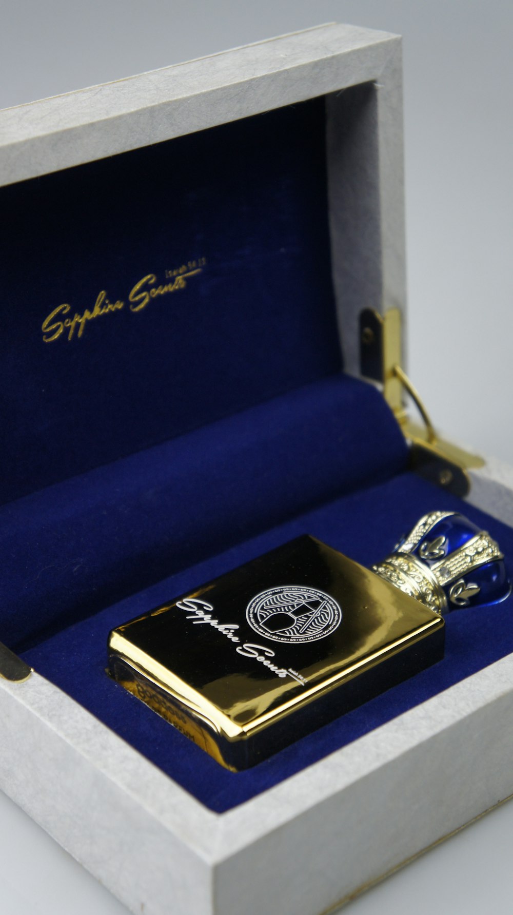 a gold plated lighter in a white box