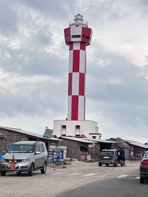 a red and white lighthouse on top of a building
