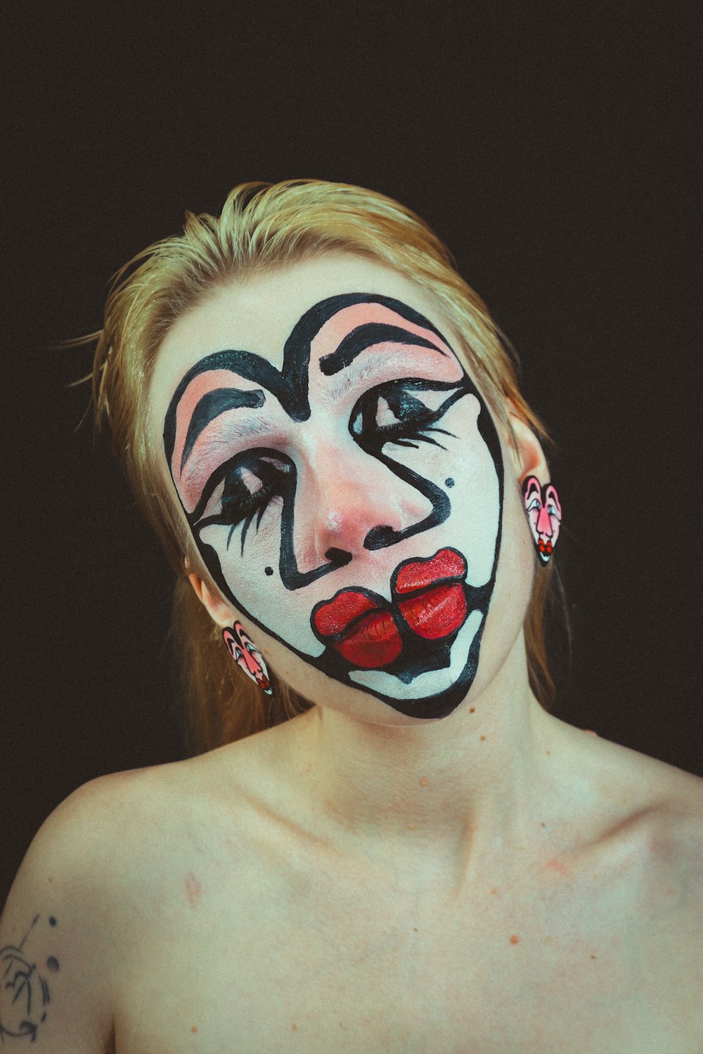 a woman with a face painted like a clown