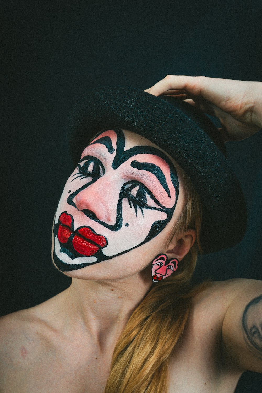 a woman with a face painted like a clown