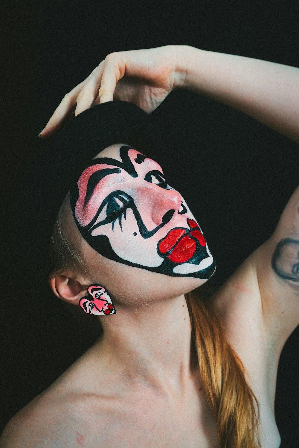 a woman with a face painted like a clown