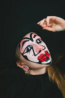 a woman with a clown makeup on her face