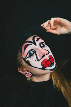 a woman with a clown makeup on her face