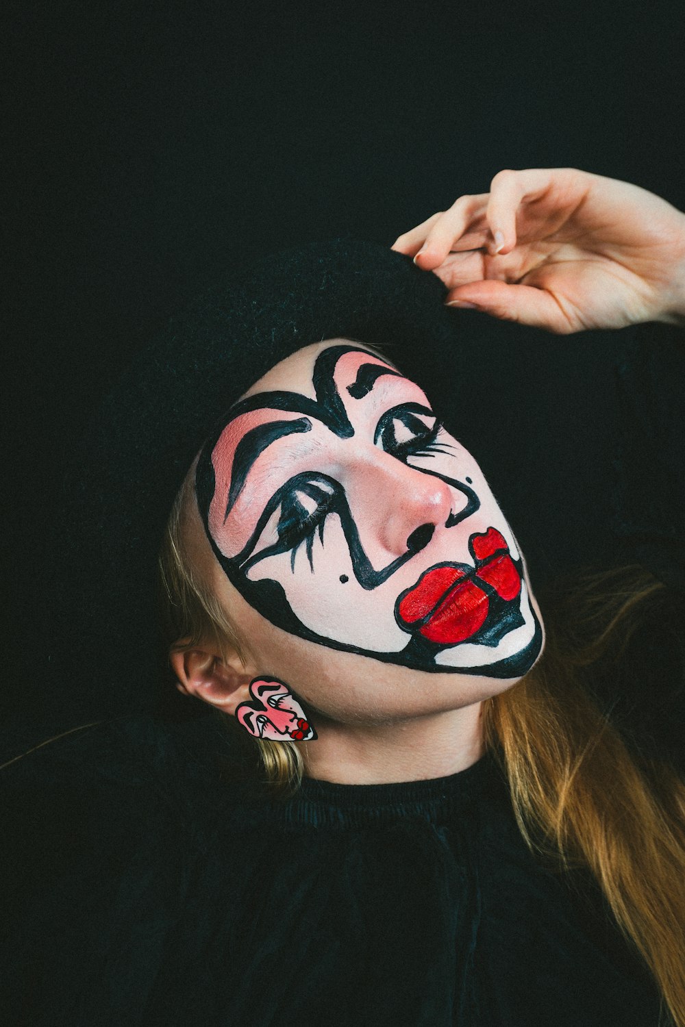 a woman with a clown makeup on her face