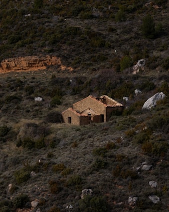 an old house in the middle of a field