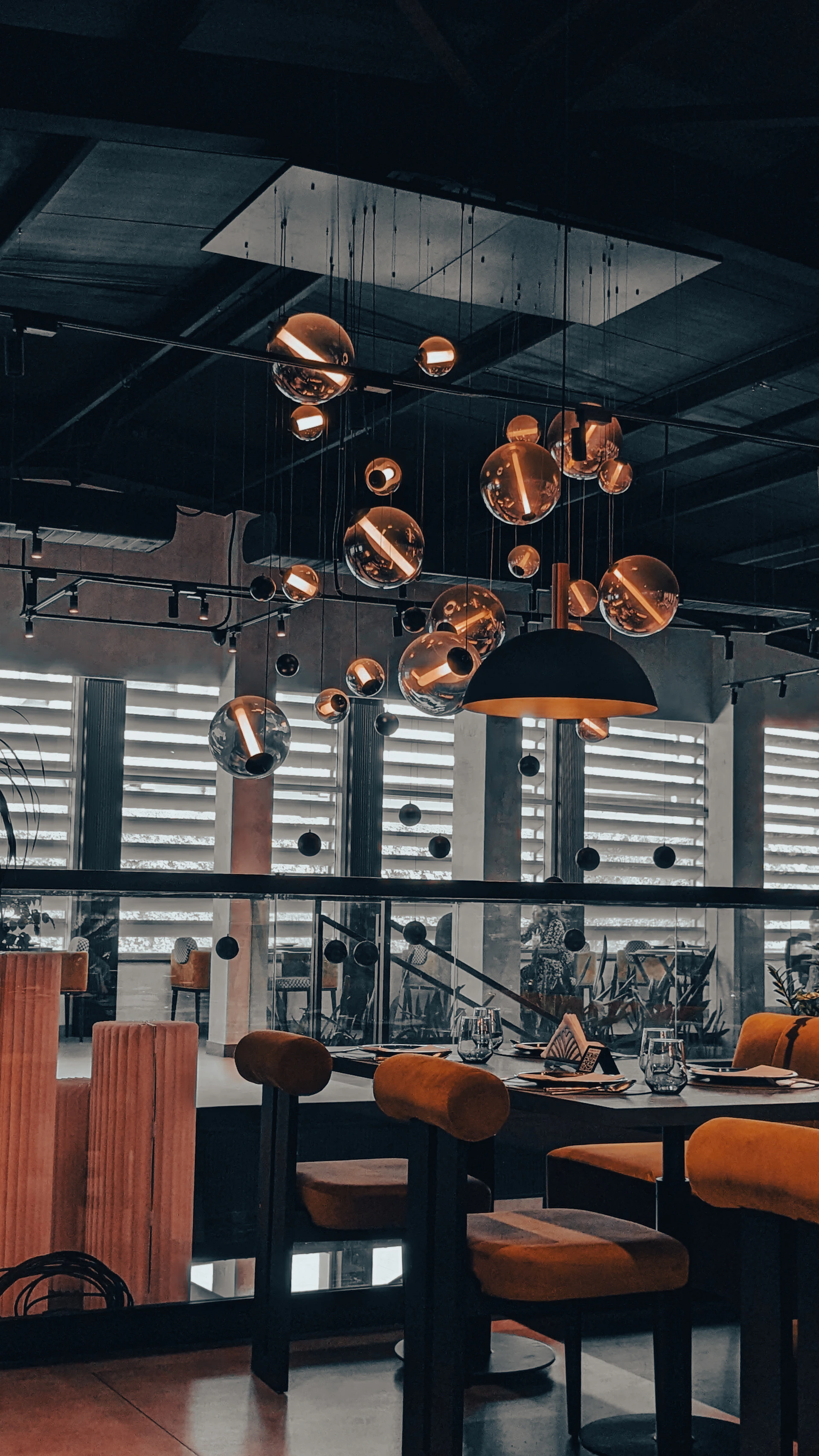 a dining room with a lot of lights hanging from the ceiling