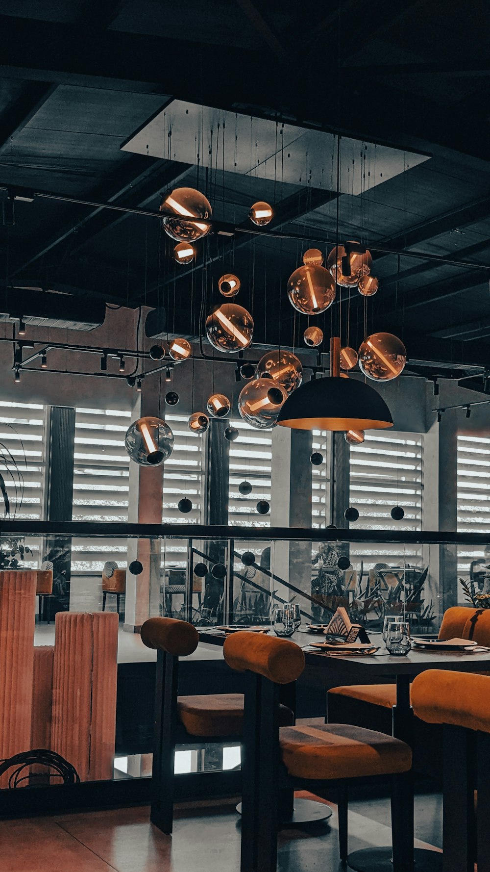 a dining room with a lot of lights hanging from the ceiling