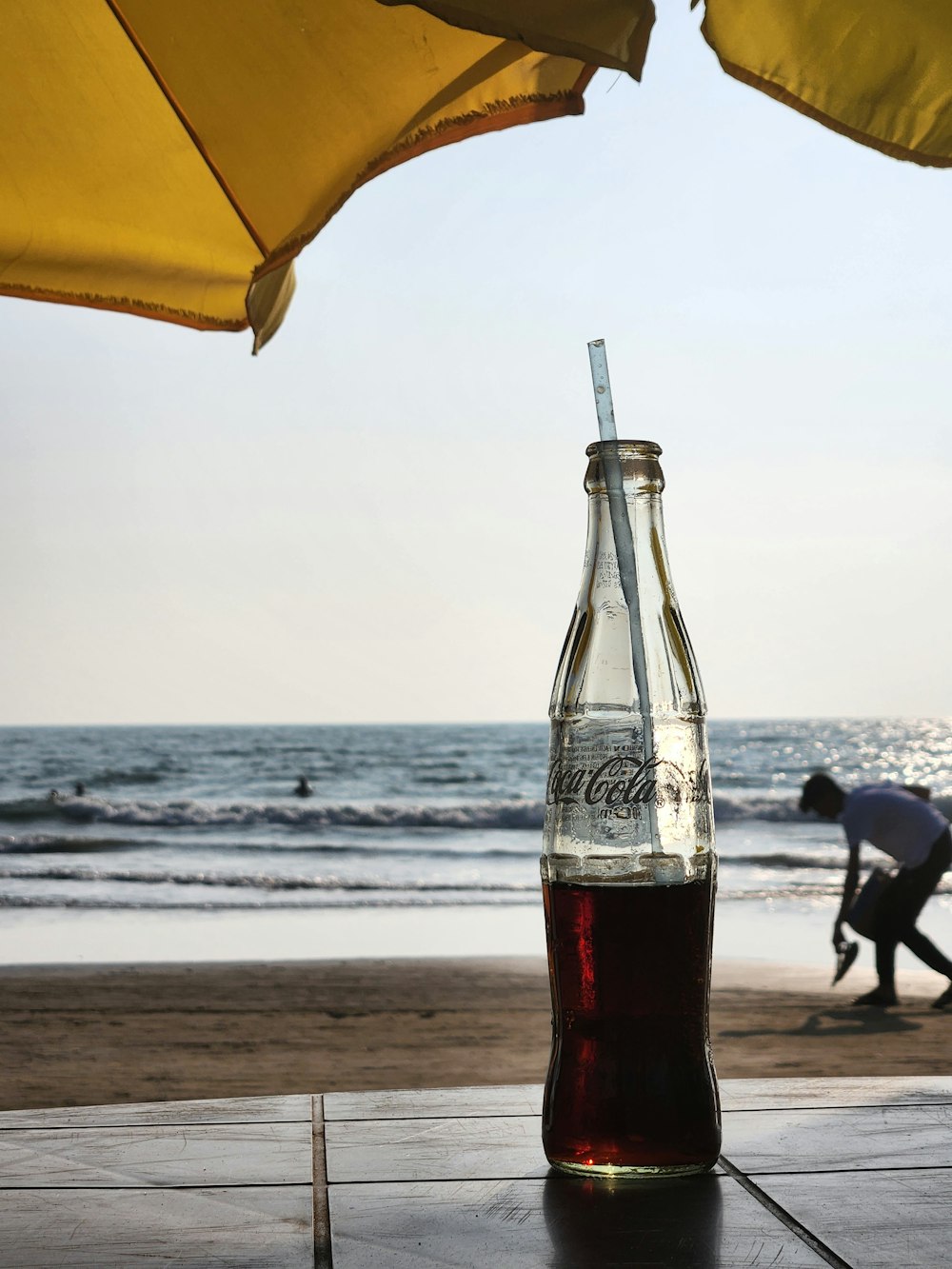 a bottle of soda sitting on top of a wooden table