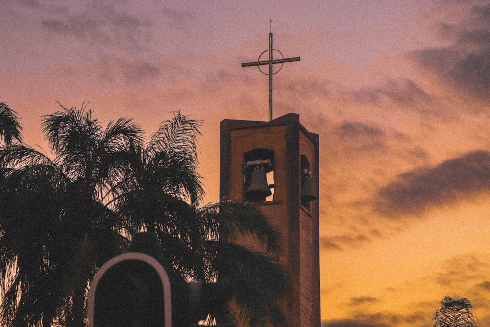 a church steeple with a cross on top of it