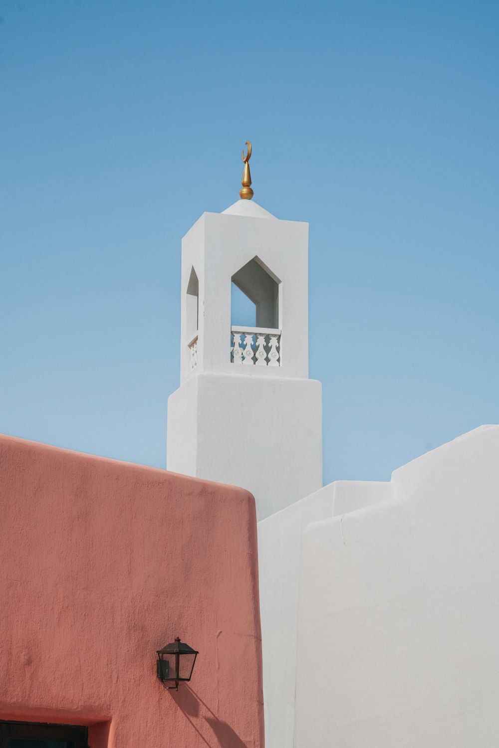 a white building with a bell tower on top of it