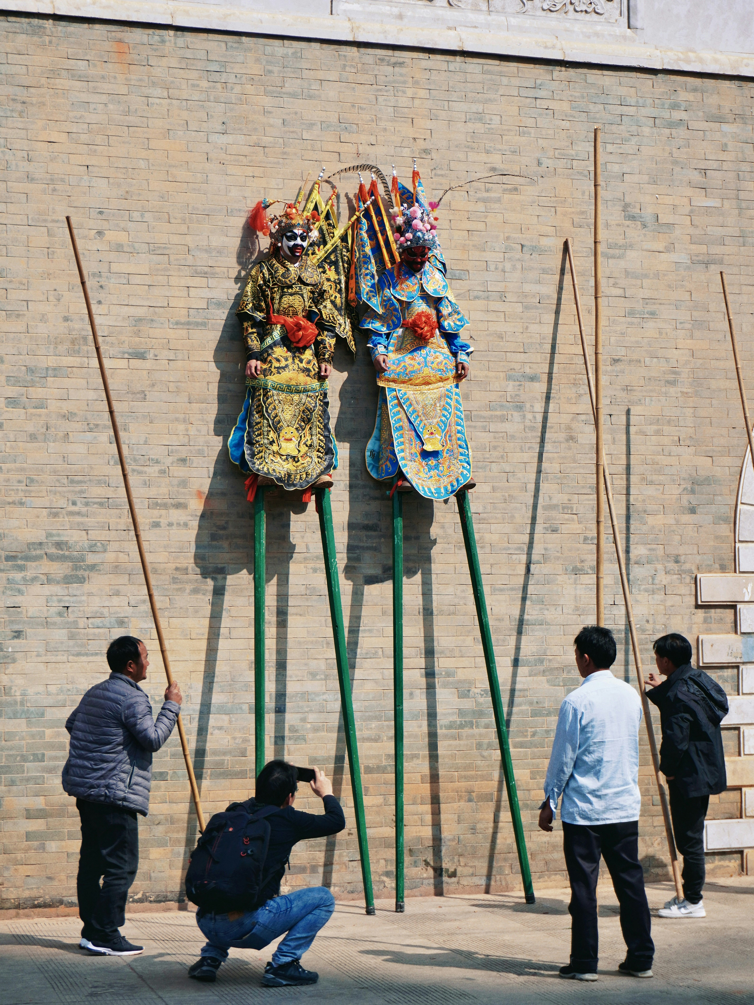 a group of people taking pictures of a sculpture