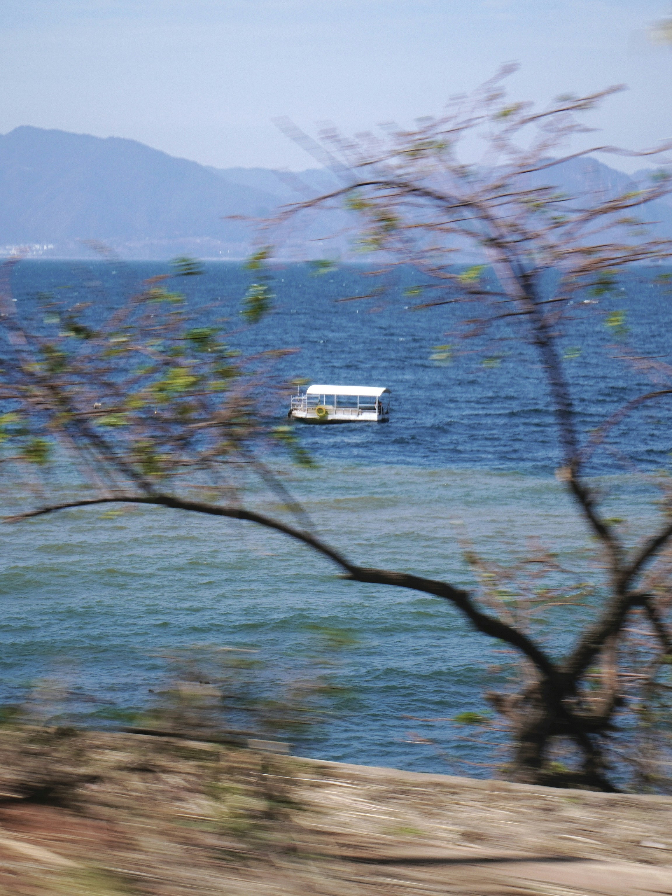 a white boat floating on top of a large body of water