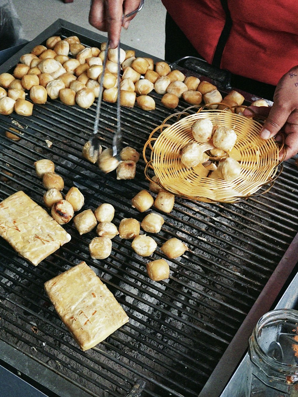 a person cooking food on top of a grill