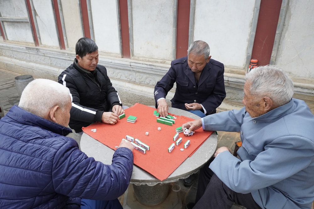 a group of people sitting around a table playing a game