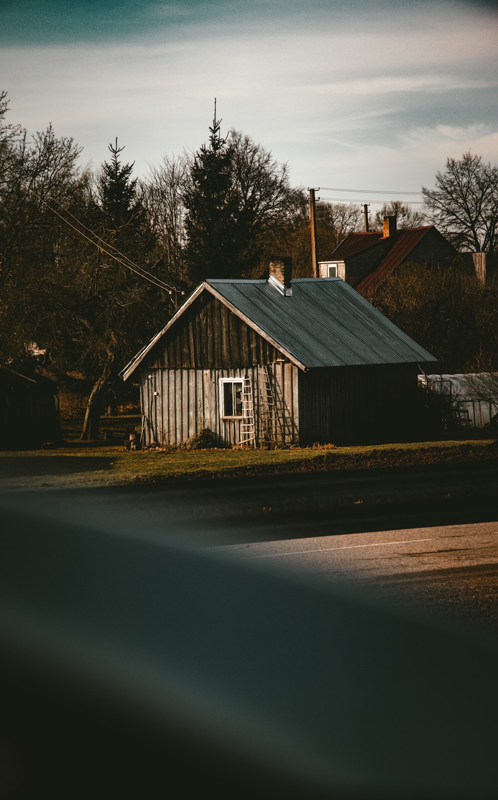 an old barn with a metal roof and a tin roof