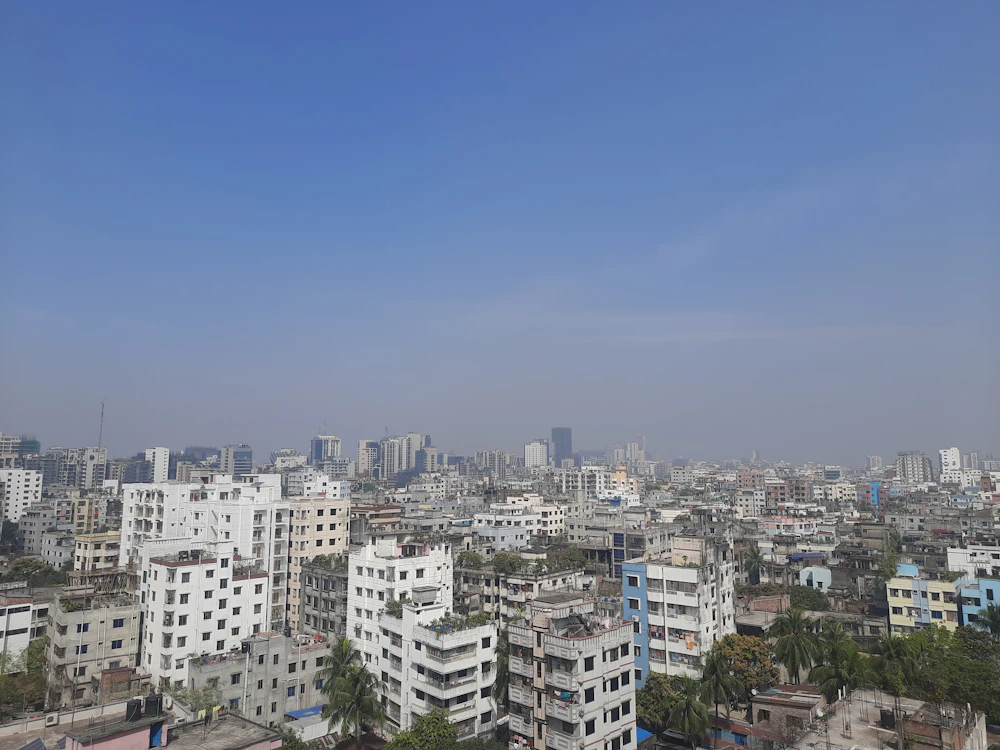 Aerial view of dense Dhaka apartment blocks under a clear sky