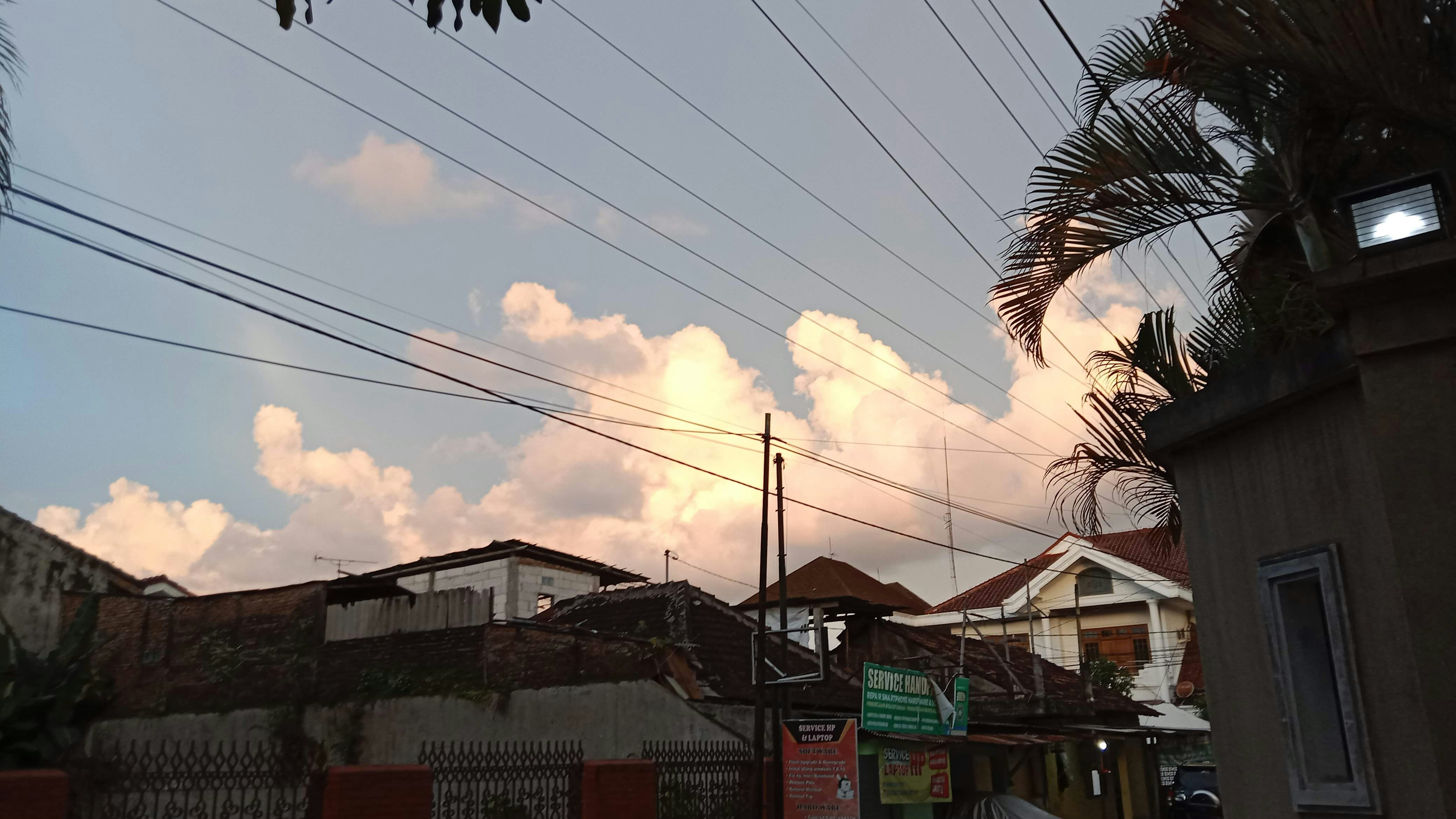 a view of a street with power lines in the background