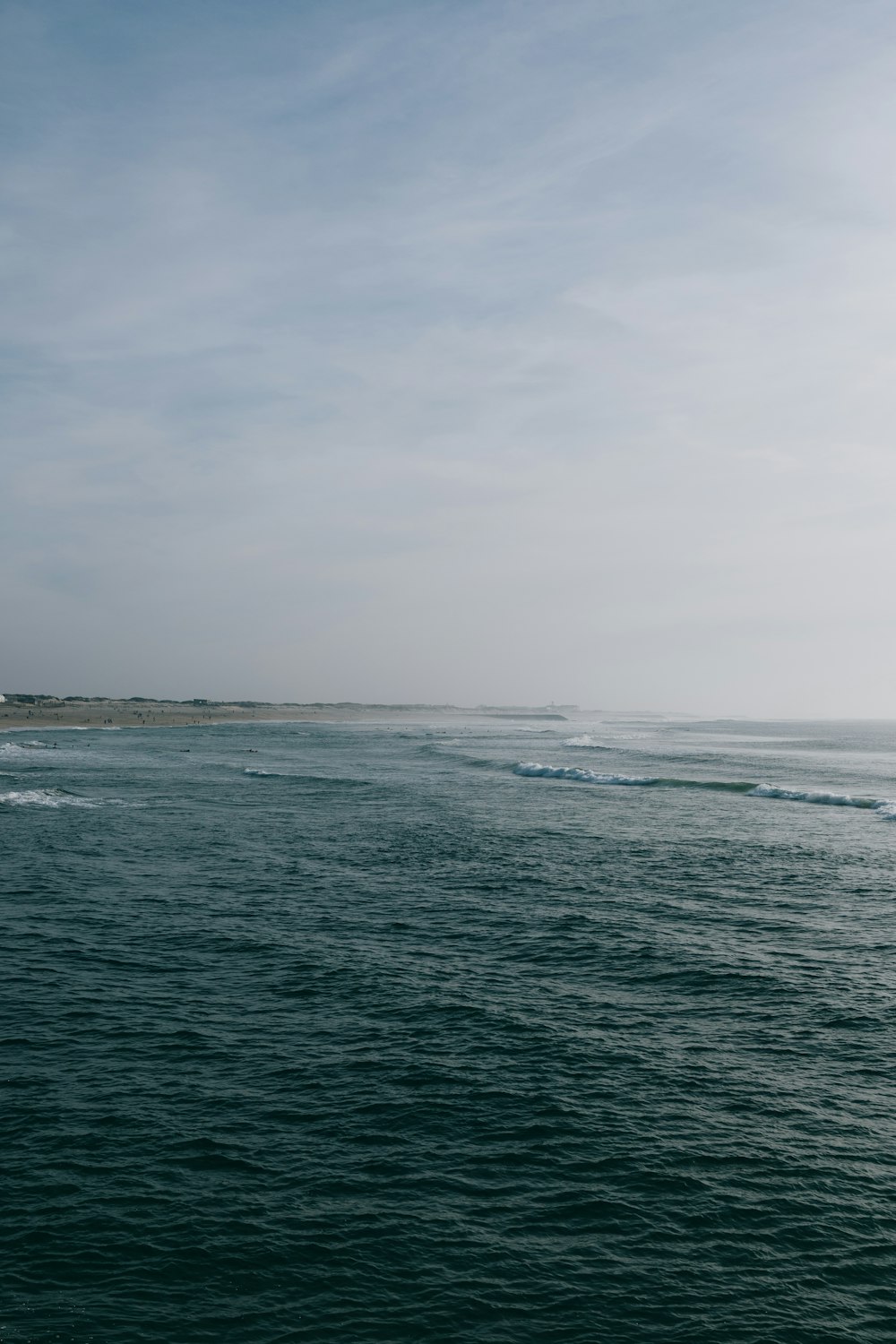 a body of water with a lighthouse in the distance