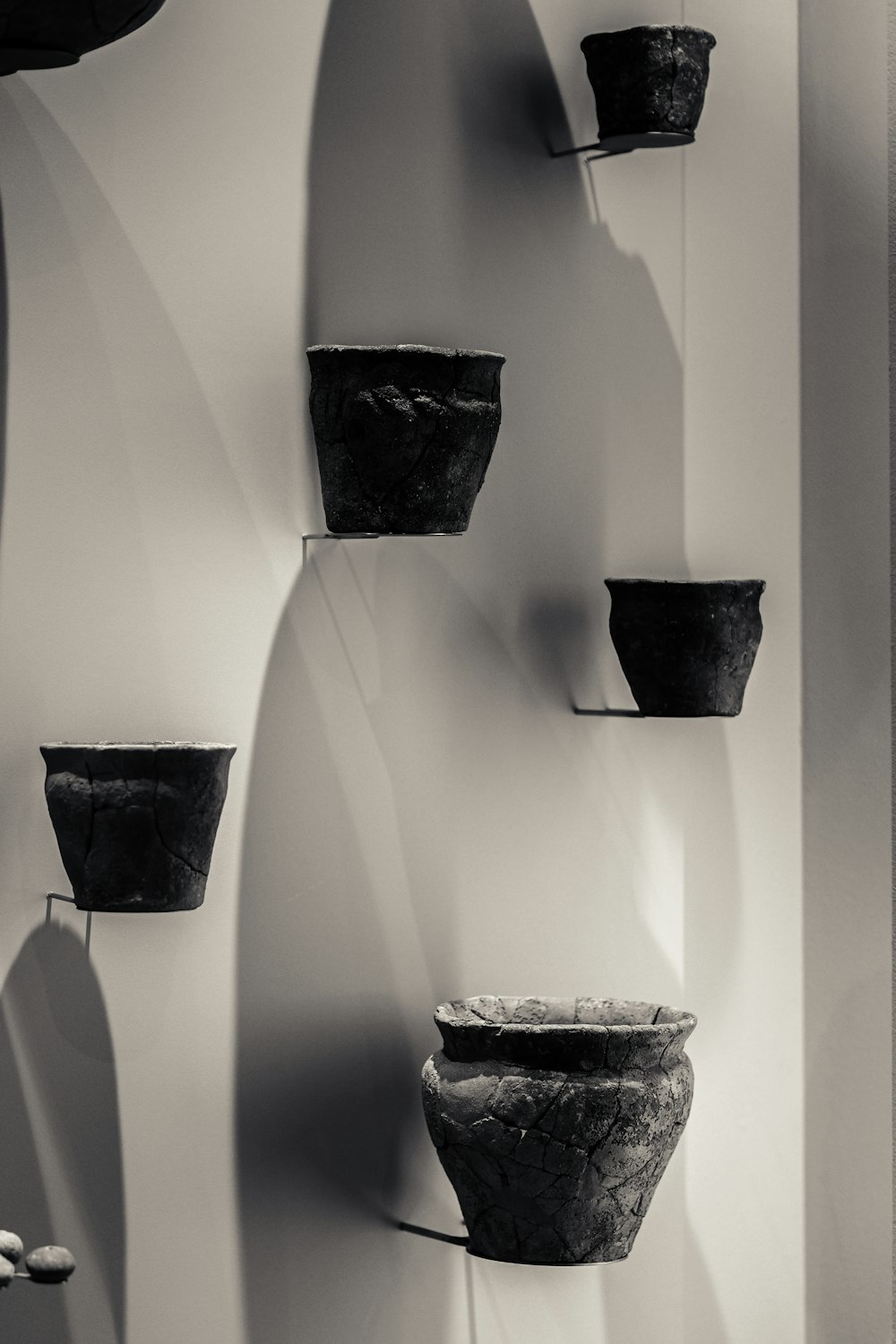 a group of pots hanging on a wall