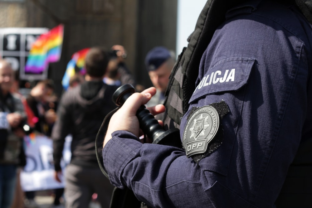 a police officer standing in front of a crowd of people