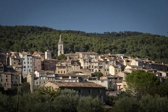 a small town with a steeple in the background