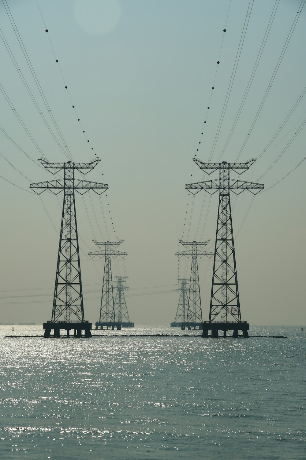 a couple of power lines sitting over a body of water
