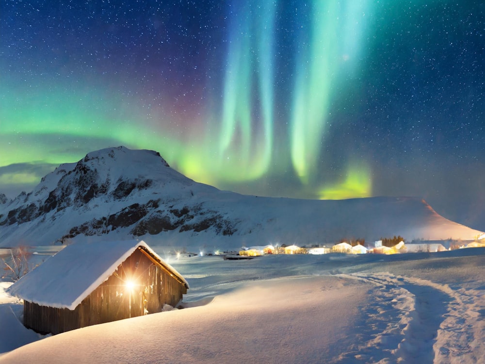 a cabin in the middle of a snow covered field