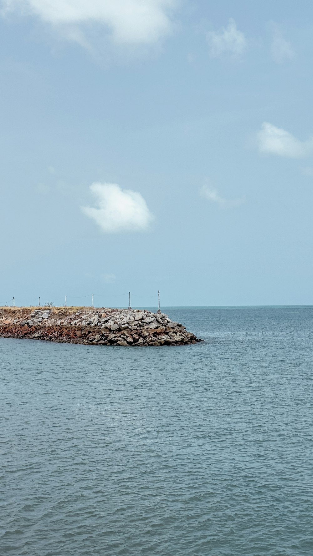 a large body of water with a small island in the middle of it