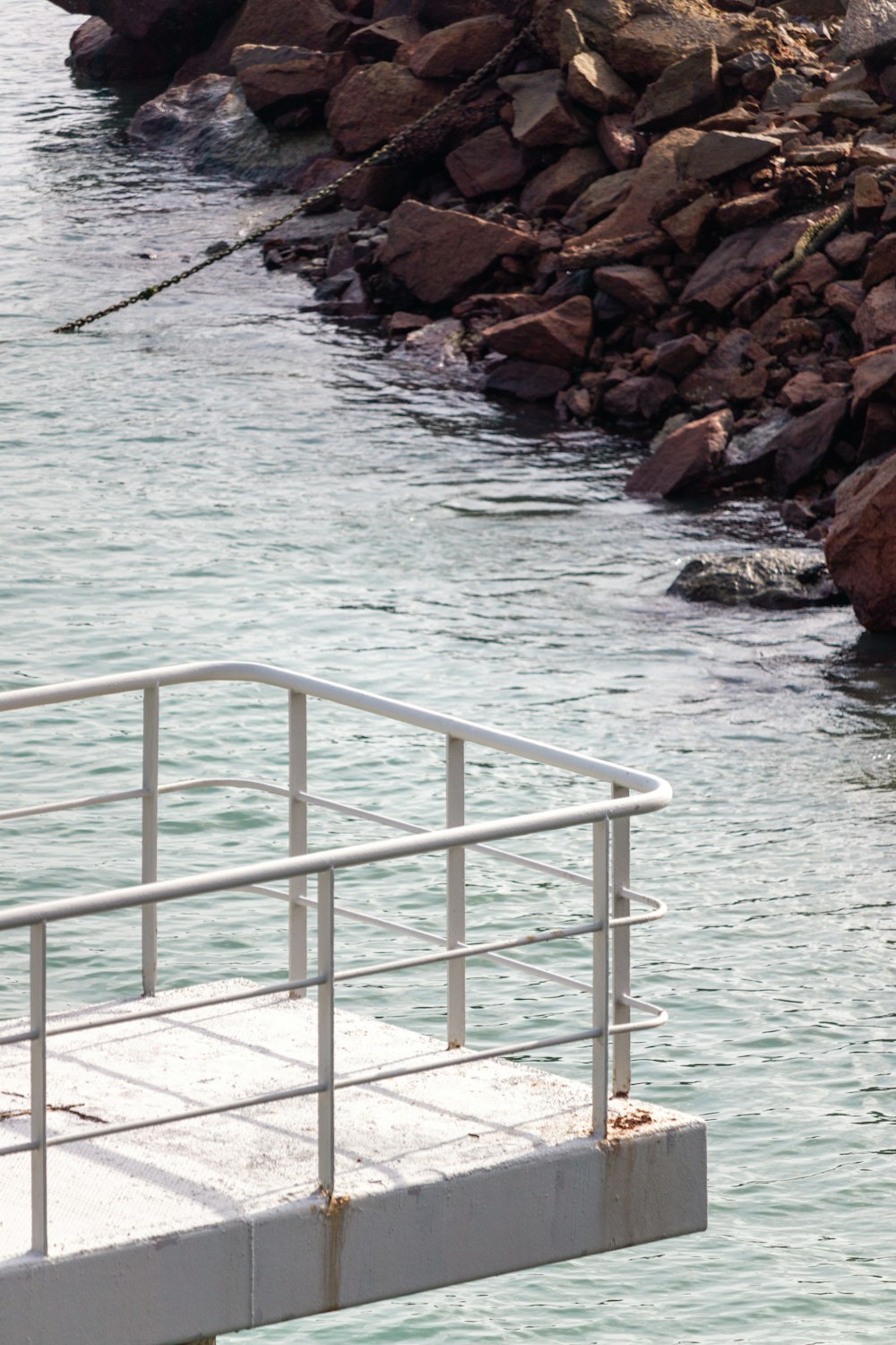 a man standing on a dock next to a body of water