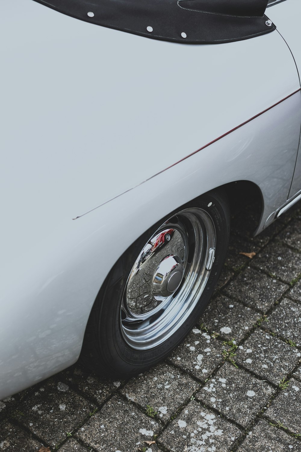 a close up of a white car parked on a street