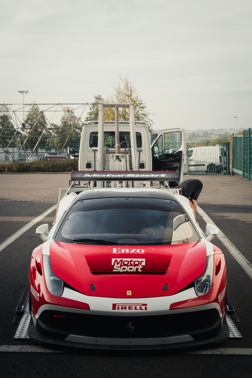 a red and white sports car parked in a parking lot