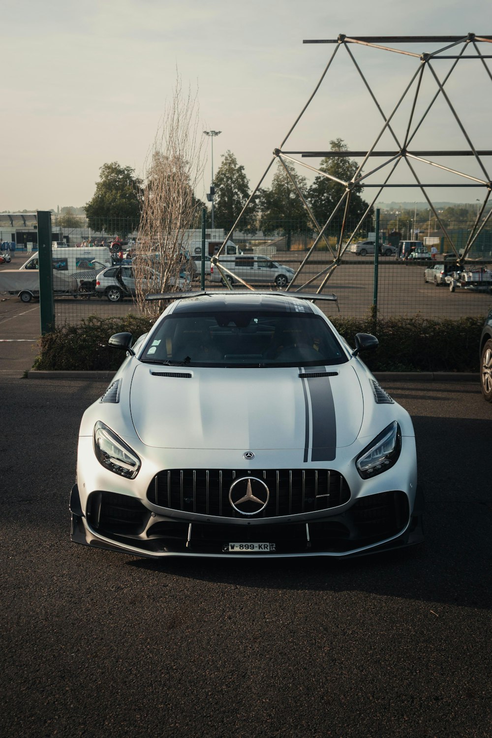 a white sports car parked in a parking lot