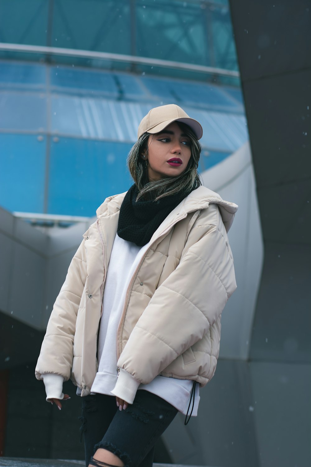 a woman in a white jacket and black pants