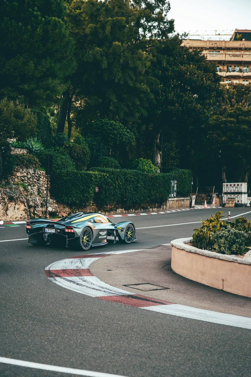 a race car driving around a curve on a road