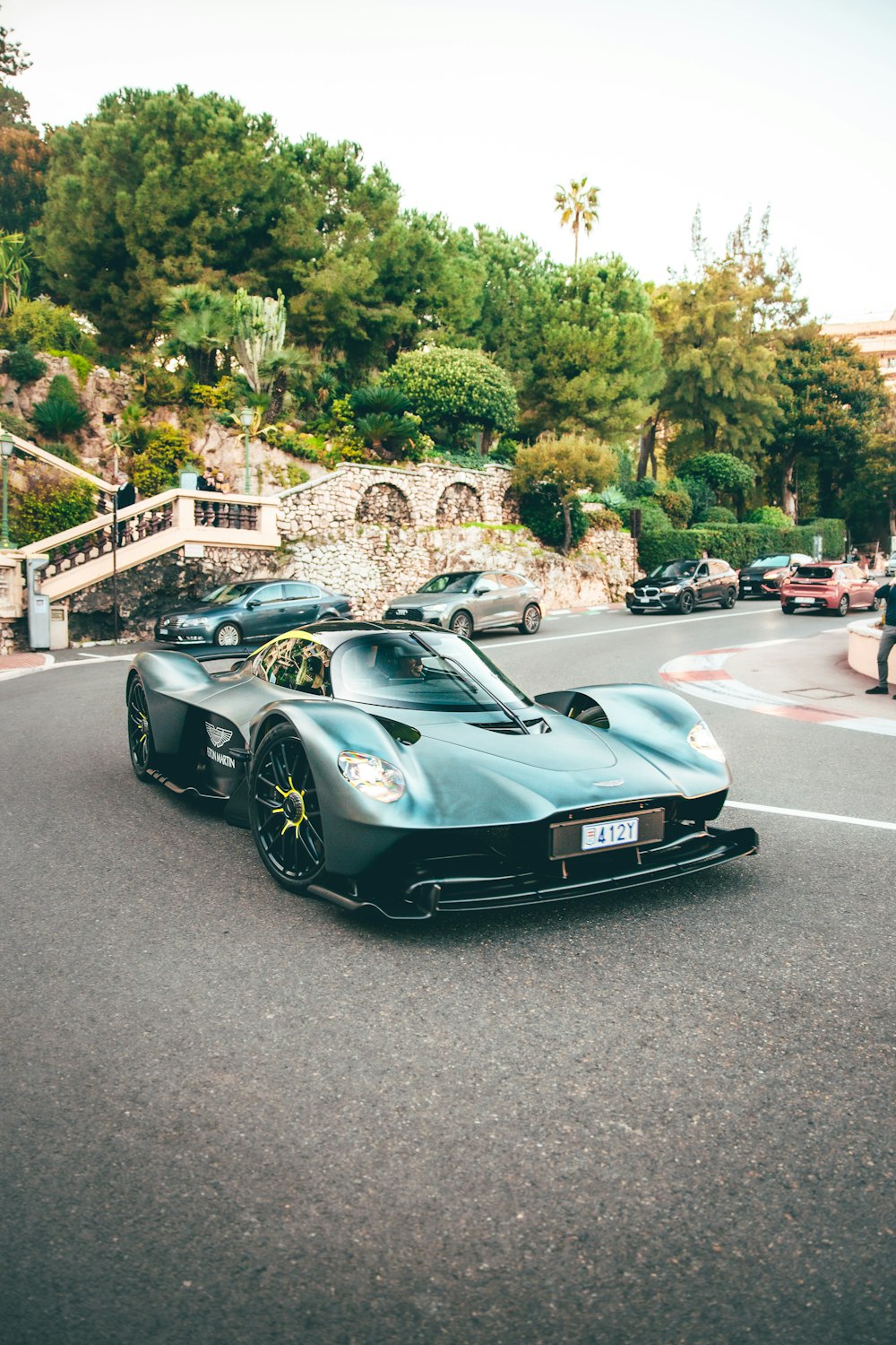 a blue sports car driving down a street